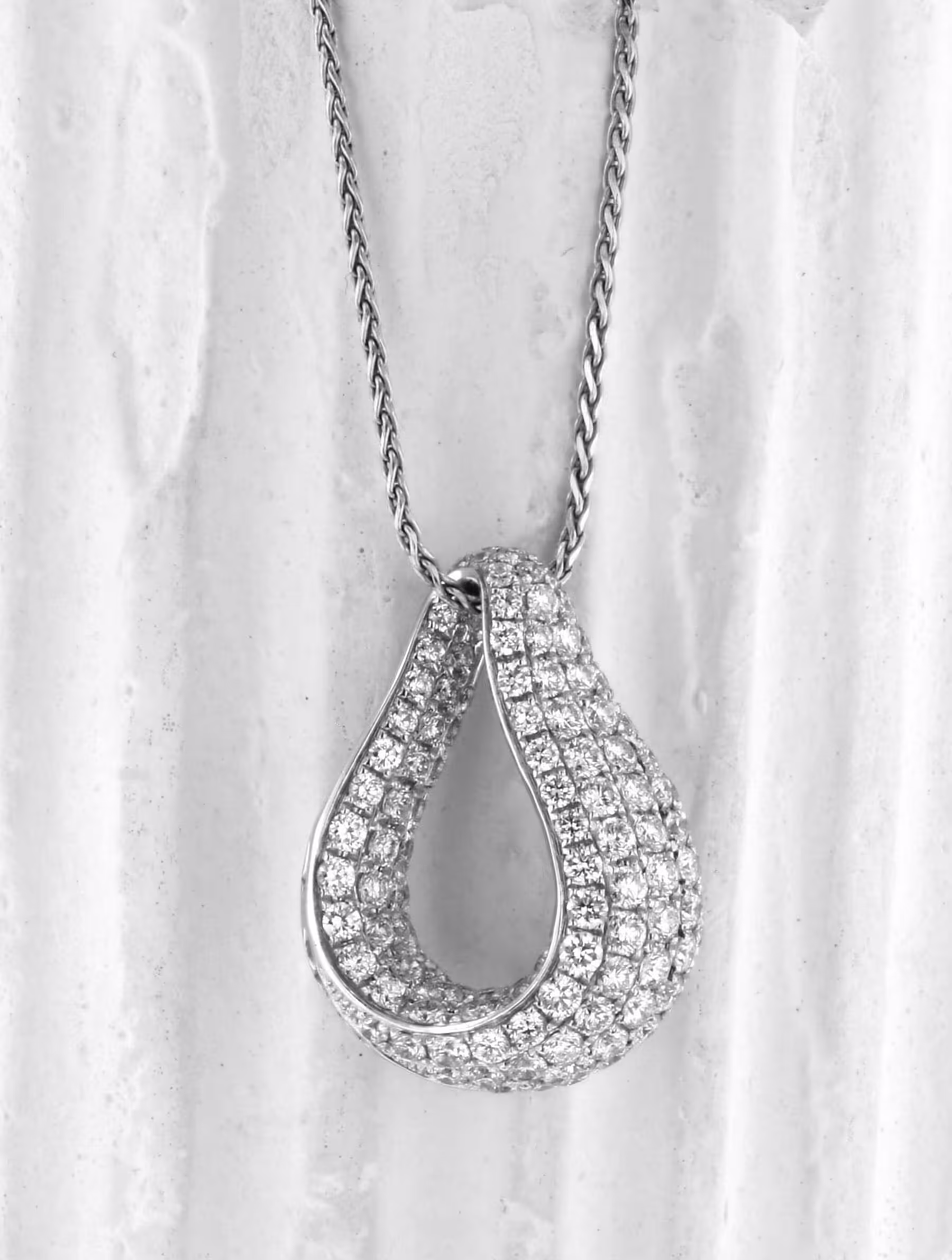 Elegant 18K gold pendant with pave-set diamonds, perfect for luxury jewelry collection.