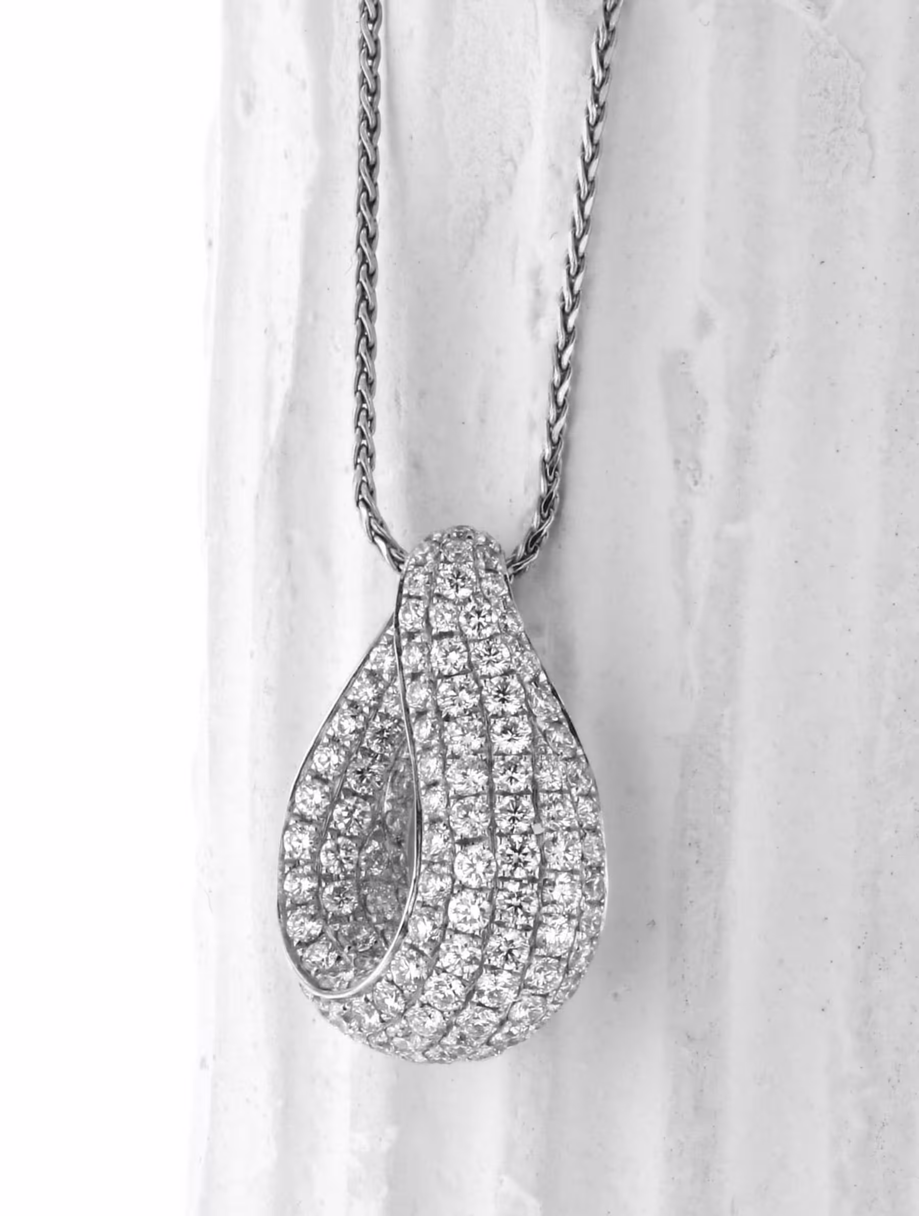Elegant 18K gold pendant with pave-set diamonds, perfect for special occasions.