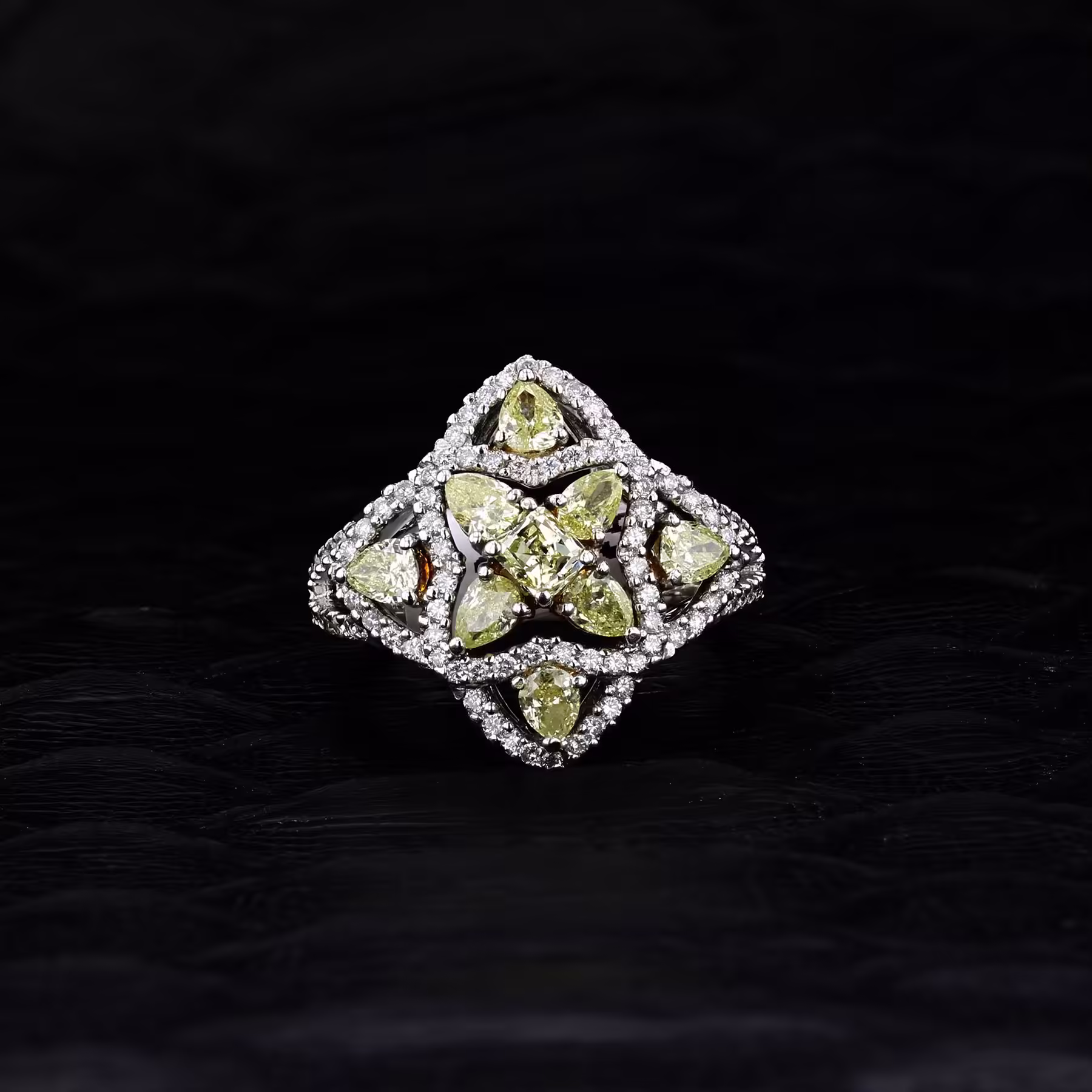 Elegant 18K yellow diamond ring with intricate design and sparkling gemstones.