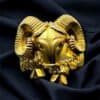 Gold ram head ring with intricate detailing, crafted over sterling silver for a unique jewelry piece.