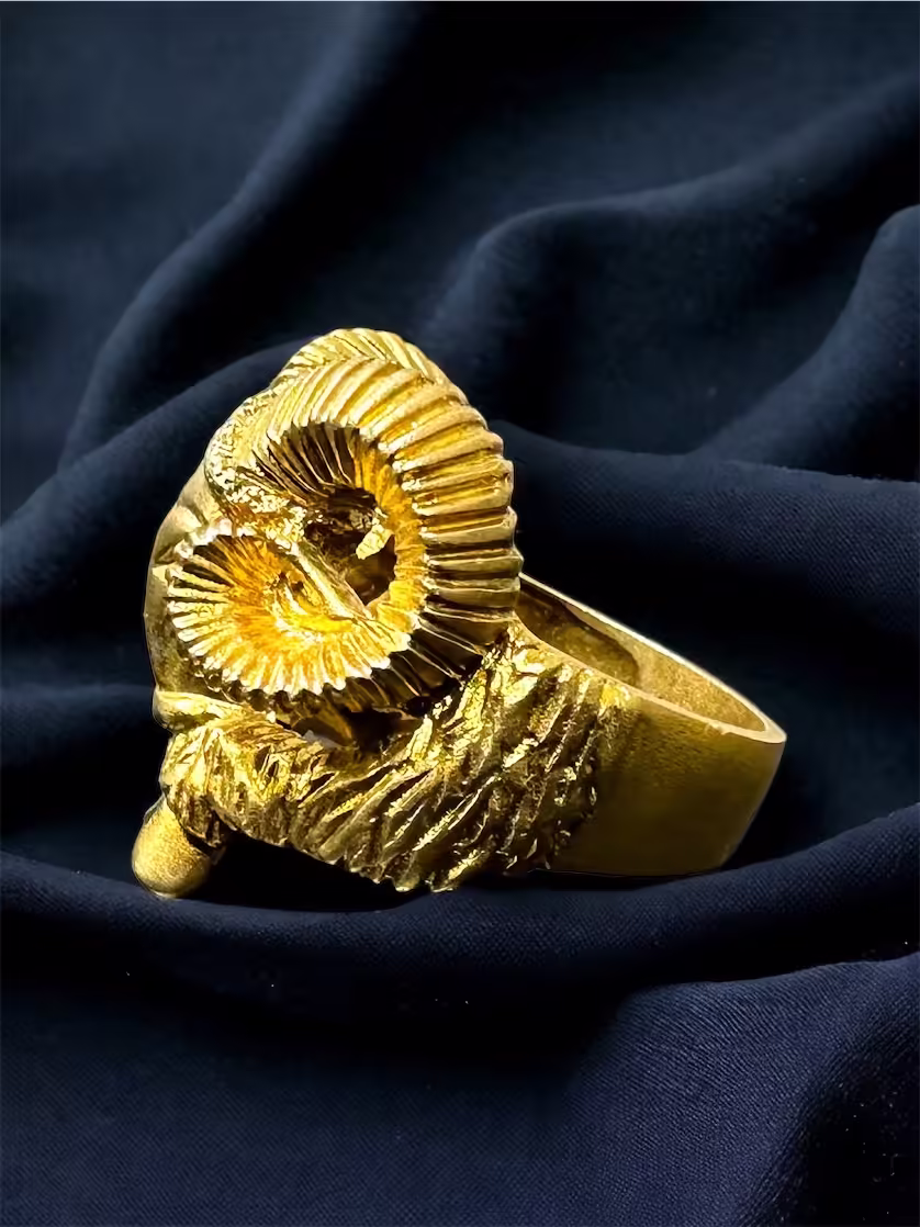 Custom gold ram ring crafted over sterling silver, unique jewelry piece.