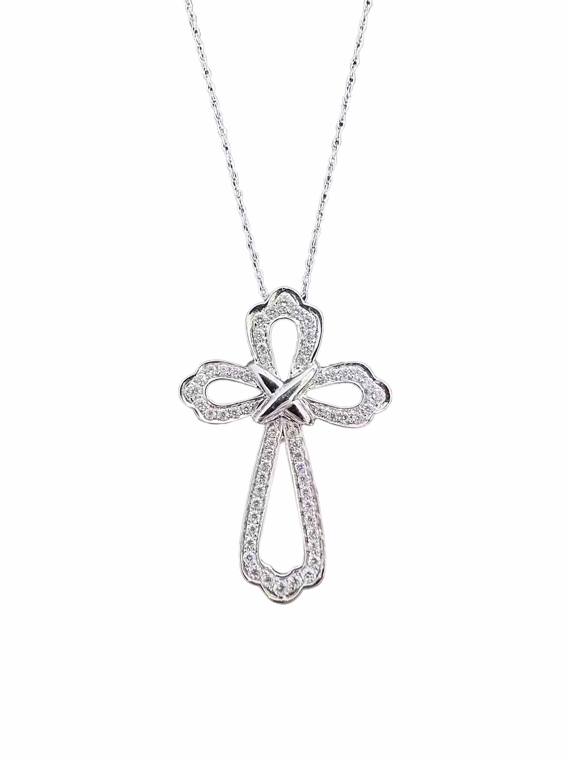 Elegant diamond cross pendant necklace in sterling silver. Perfect for religious or stylish jewelry.