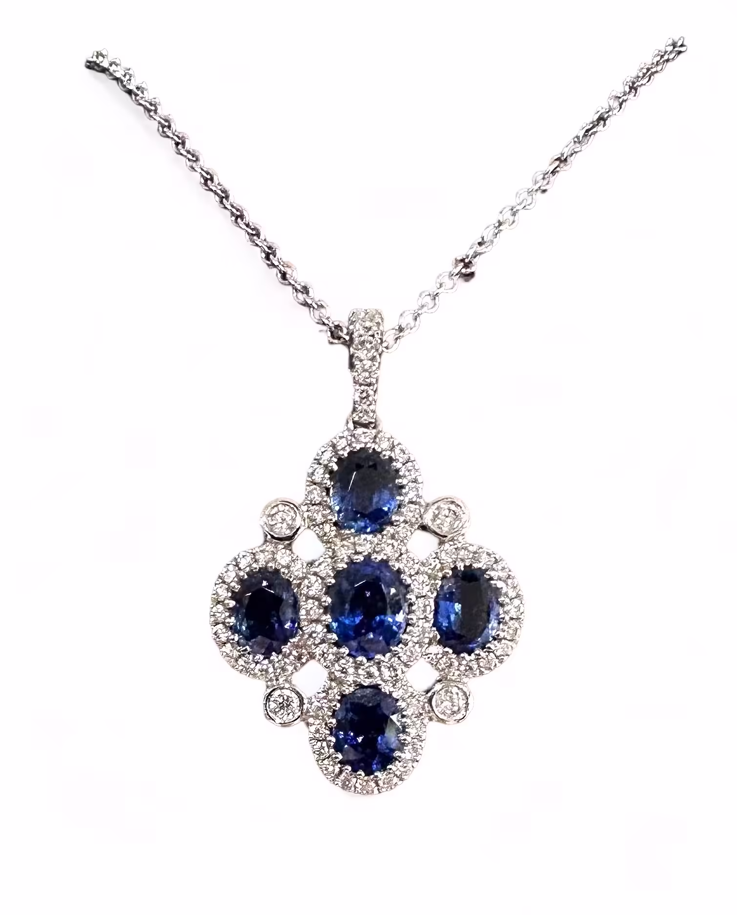 Elegant 18K gold pendant featuring deep blue sapphires and sparkling diamonds. Perfect for jewelry c.