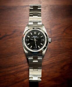 Rolex Lady No-Date luxury watch with black dial and stainless steel band. Perfect for elegant jewelr.