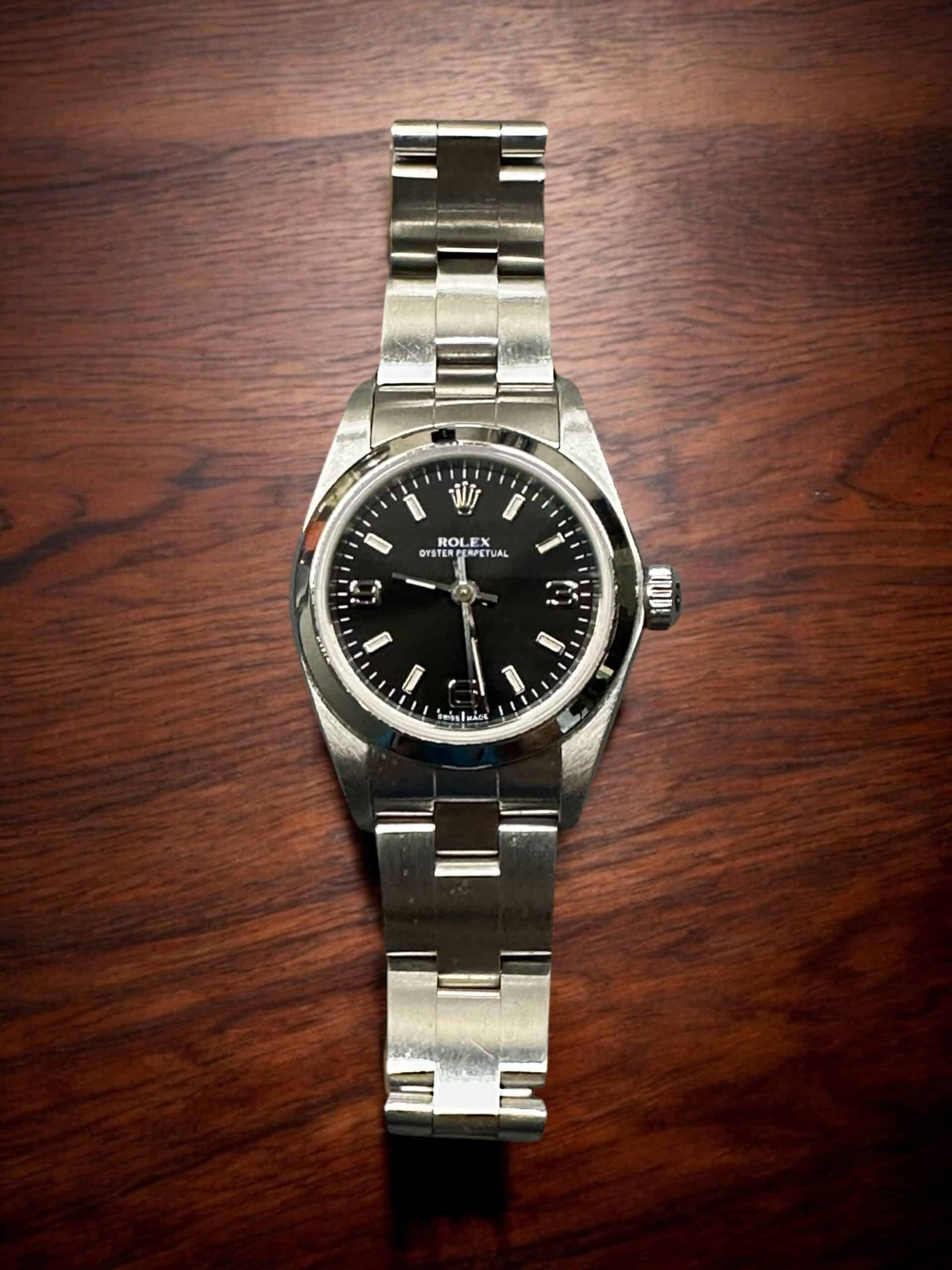 Rolex Lady No-Date luxury watch with black dial and stainless steel band. Perfect for elegant jewelr.