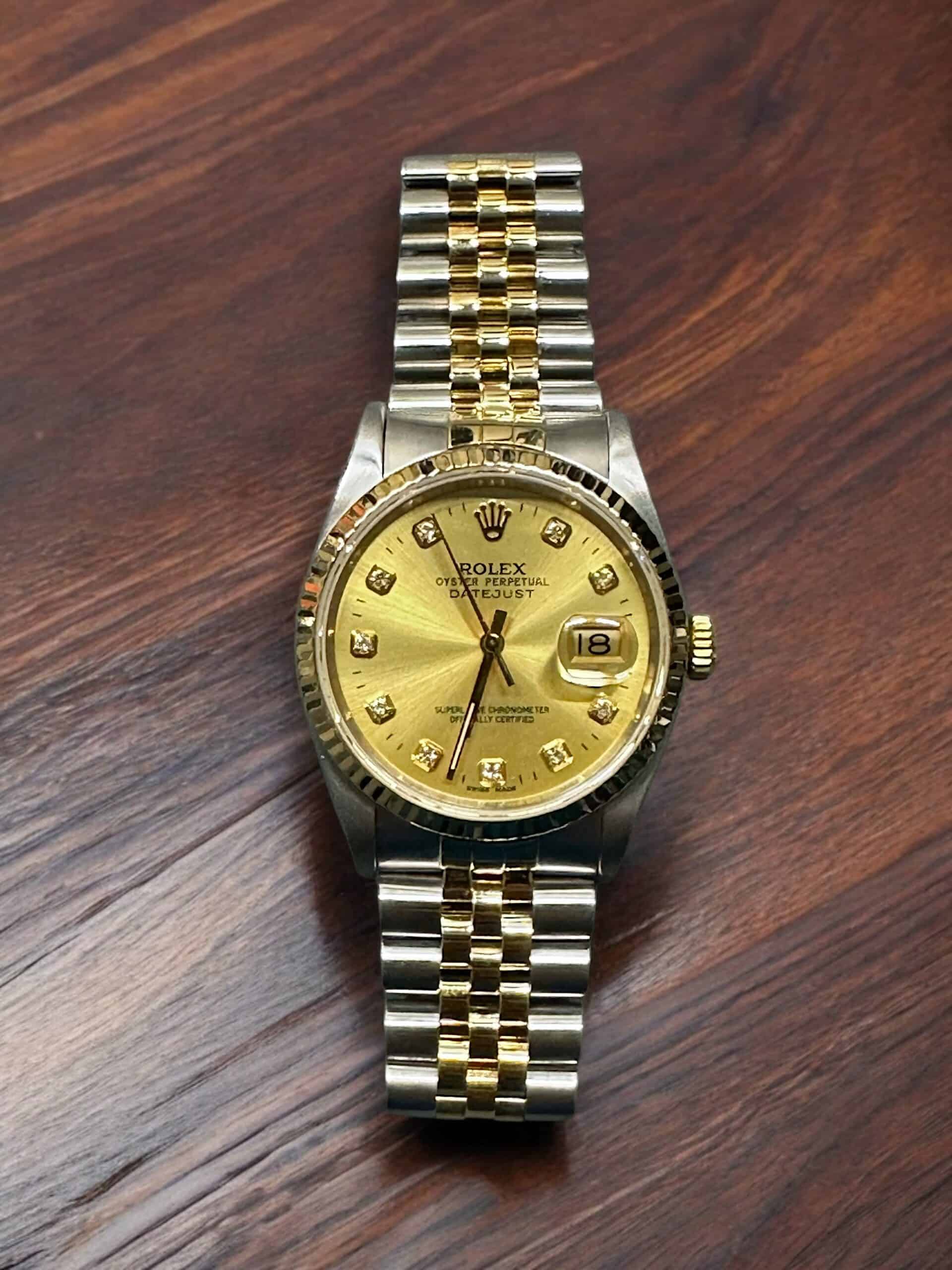 Rolex Datejust 36mm luxury watch with gold dial and diamond hour markers. Perfect for collectors and.