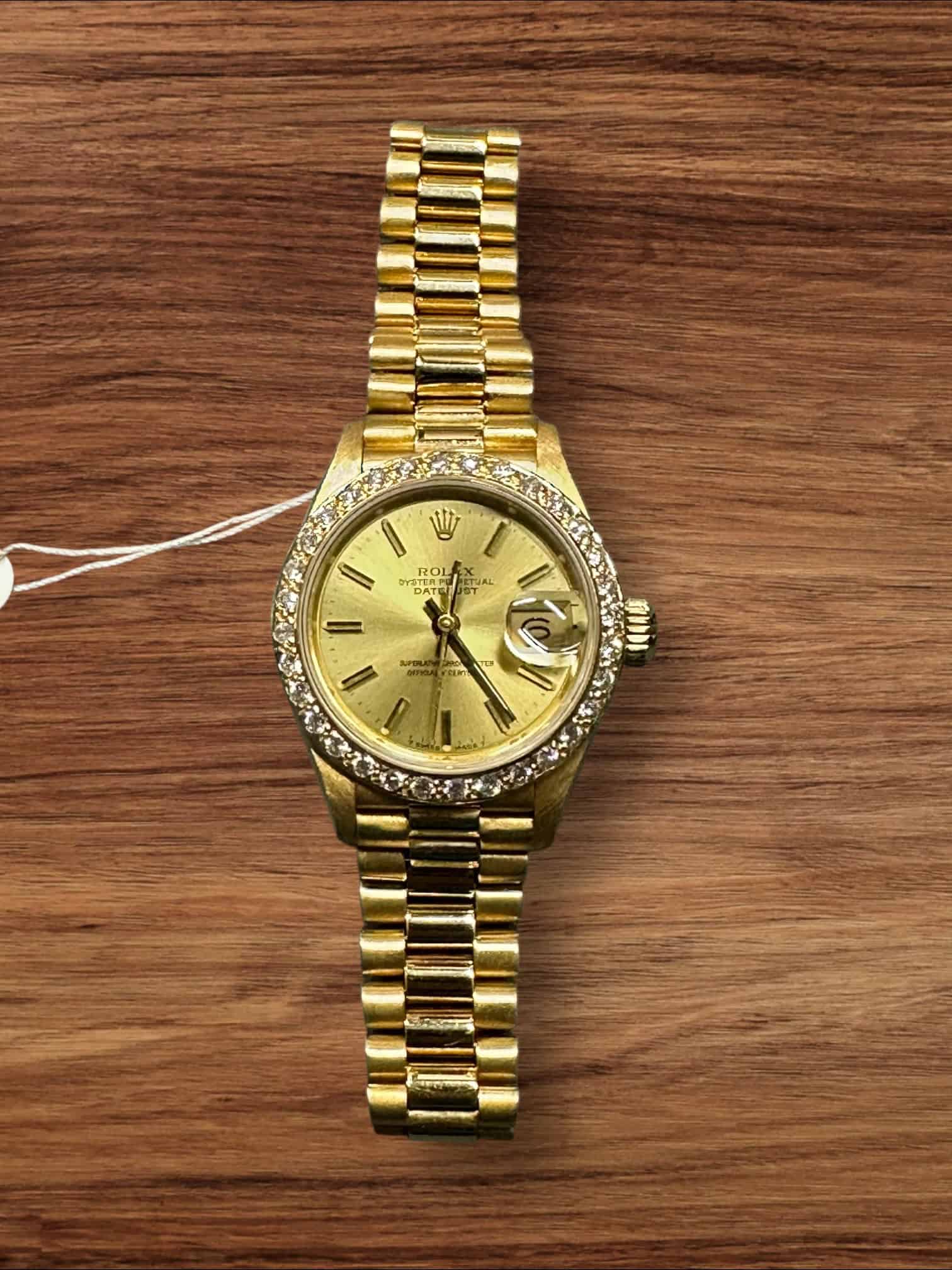 Luxury 18K gold Rolex Lady President watch with diamond bezel.