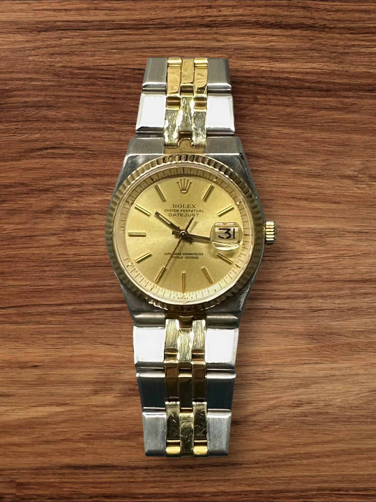 Rolex Datejust luxury watch with gold and stainless steel bracelet, gold dial, and date display.