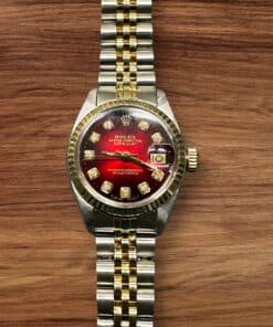 Rolex Lady Datejust luxury watch with diamond hour markers and two-tone bracelet.