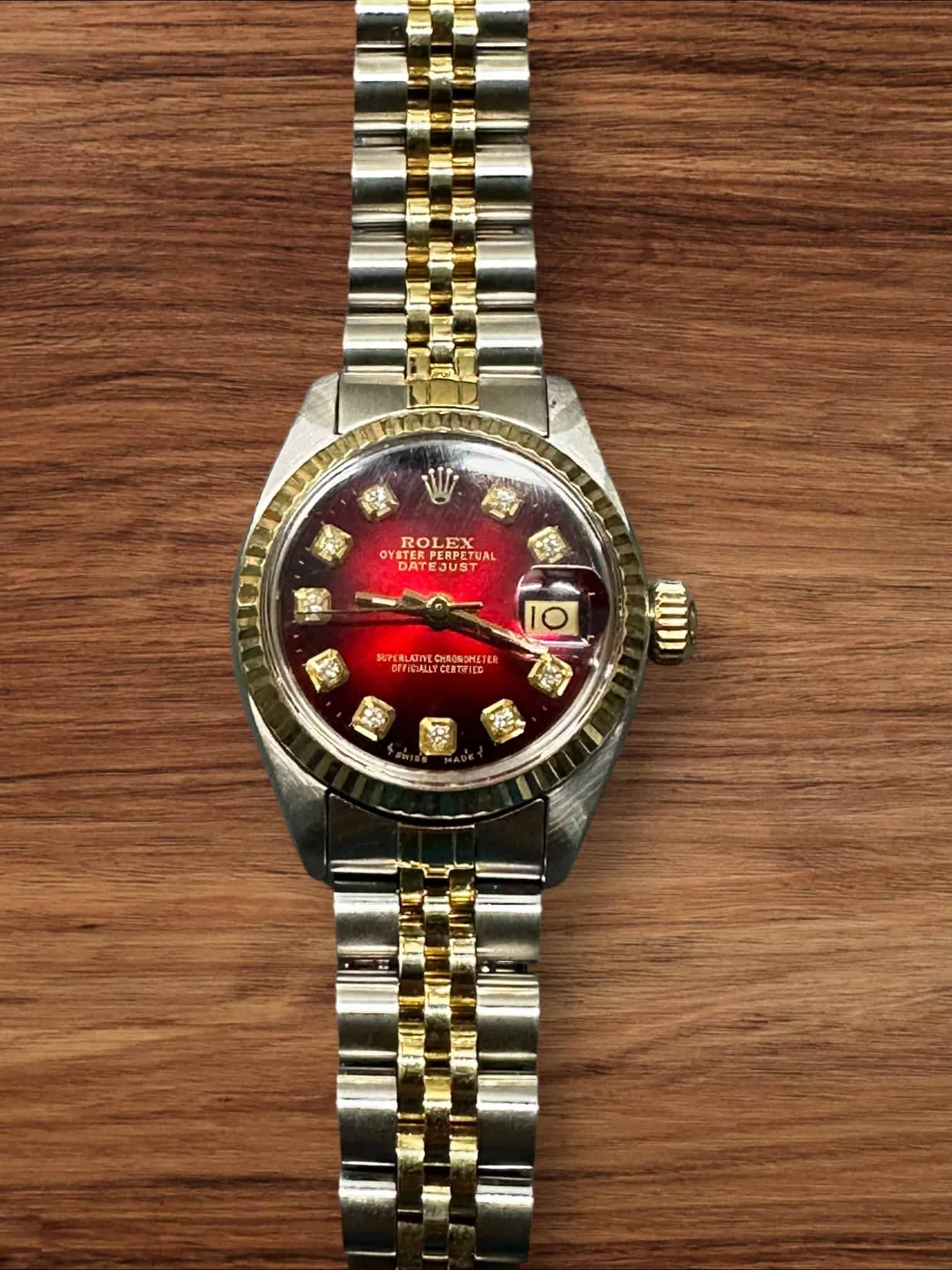 Rolex Lady Datejust luxury watch with diamond hour markers and two-tone bracelet.