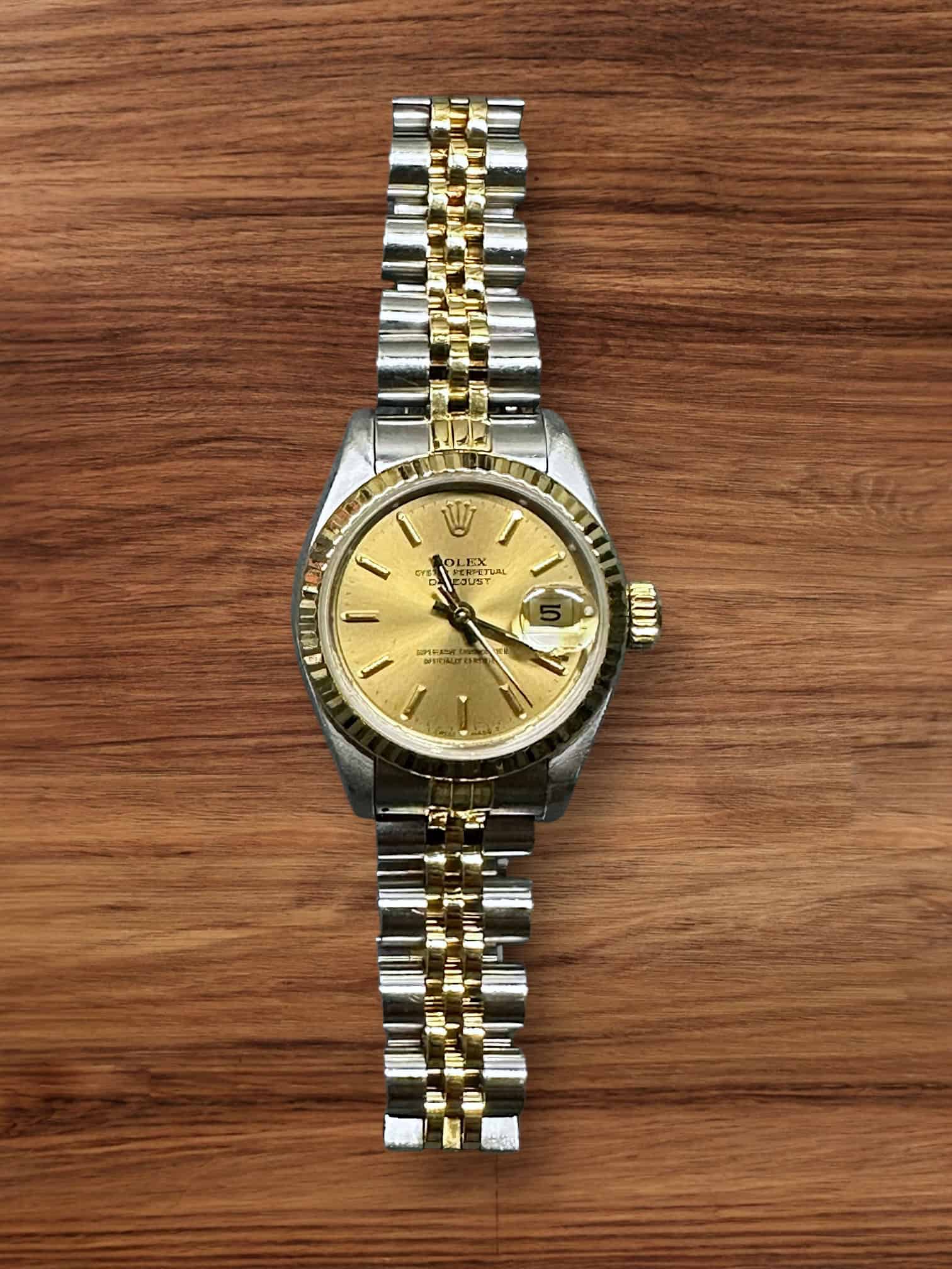 Rolex Lady Datejust 26mm luxury watch with gold dial and two-tone bracelet.